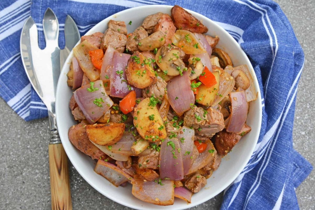 Overhead of steak stir fry in a white serving bowl 