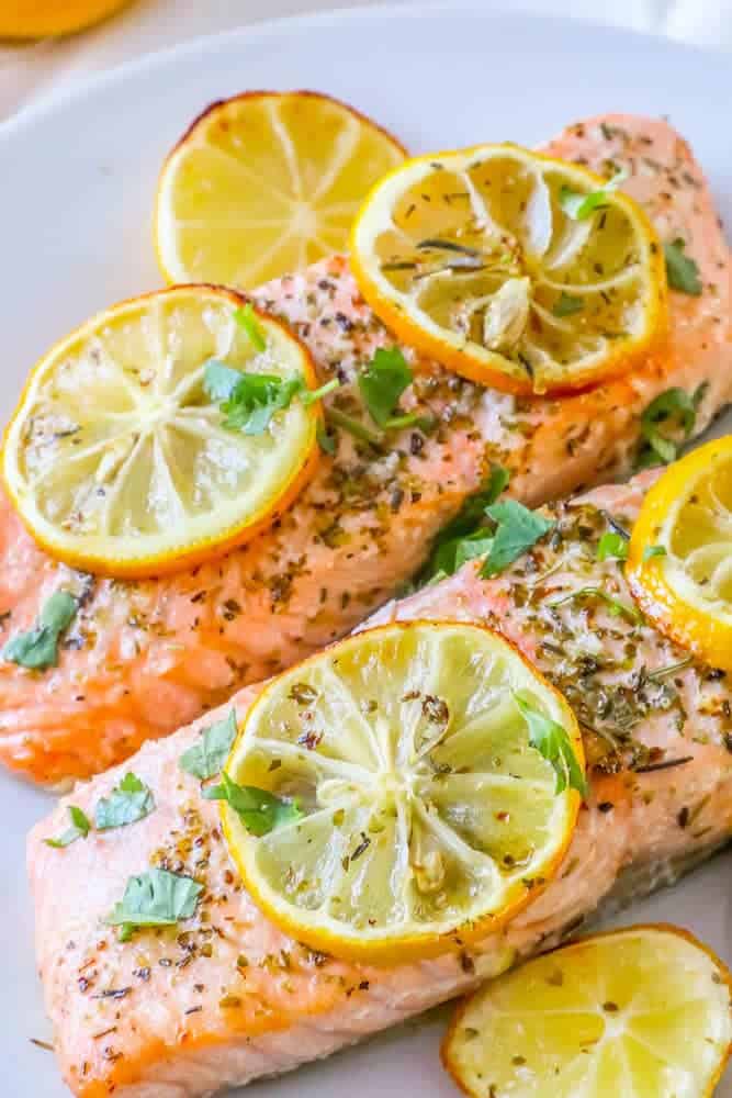 Close up of air fryer salmon topped with lemon slices