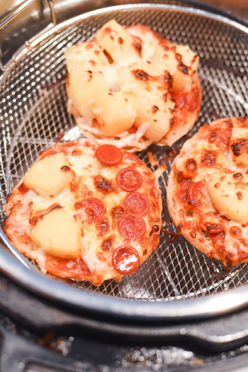 Air fryer english muffin pizzas in an air fryer basket