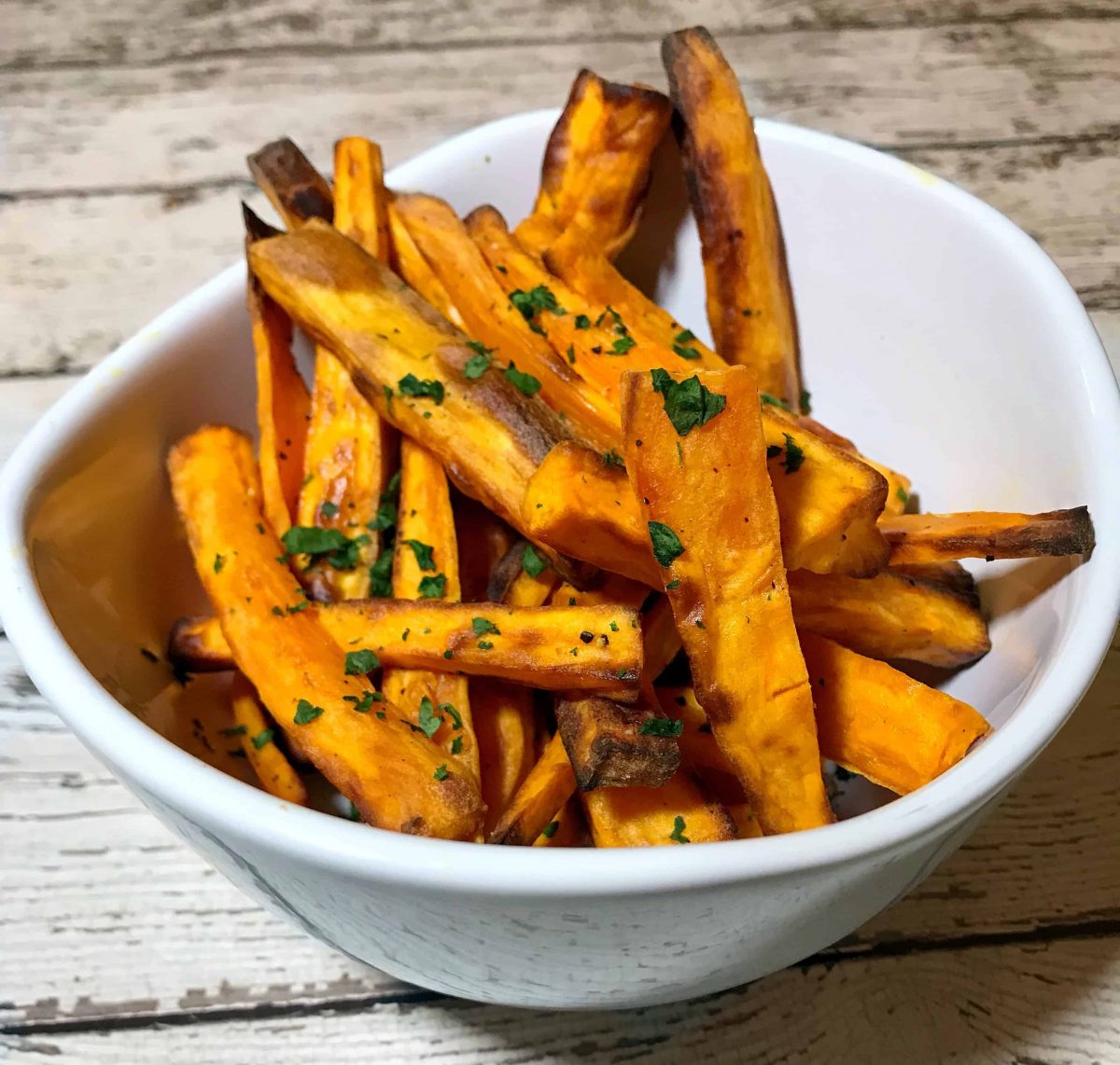 Air fryer sweet potato fries in a white bowl
