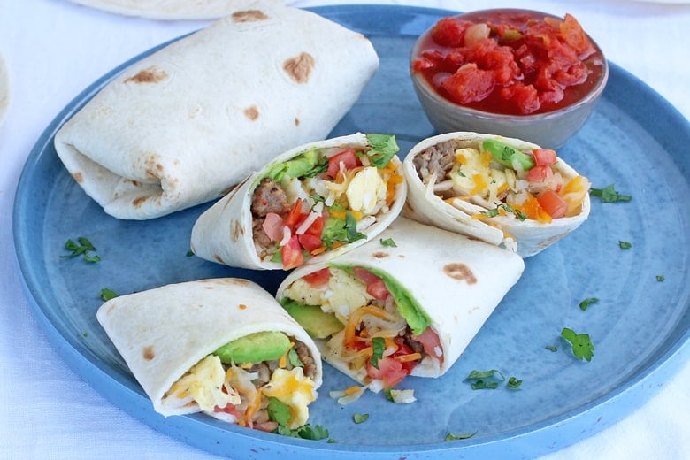 Plated breakfast burritos with salsa on a blue plate