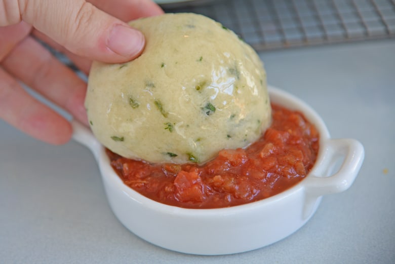 Mexican bread dipping in salsa 