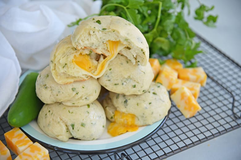 Wide shot of cheesy Mexican bread on a cooling rack 