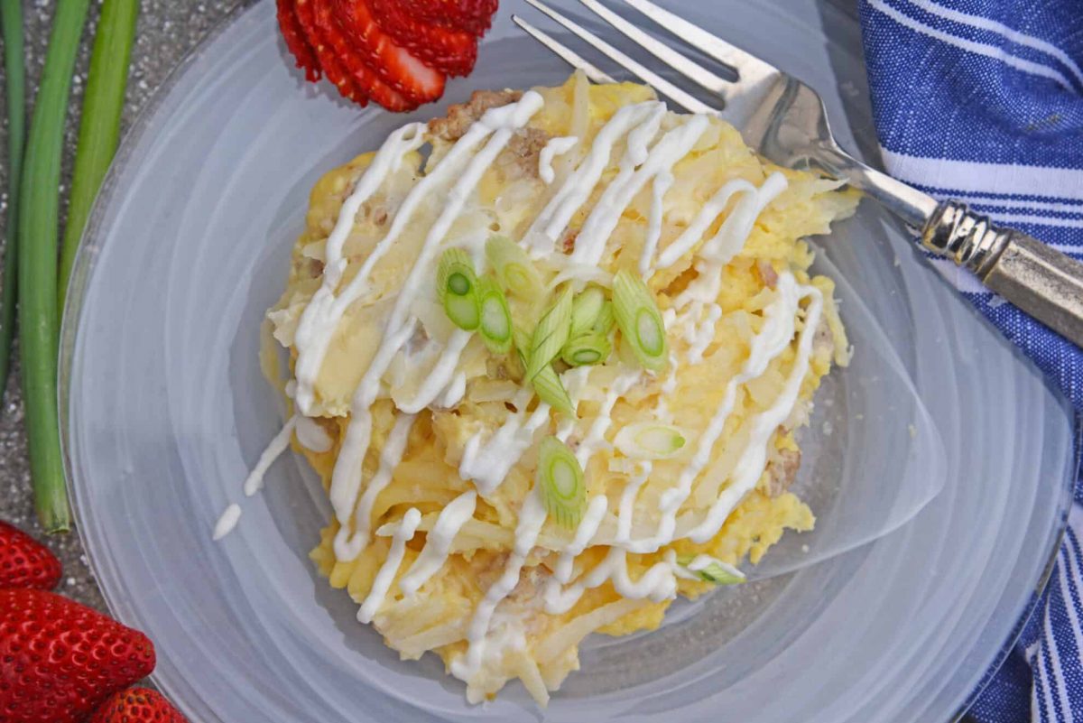 Overhead of breakfast casserole on a plate with strawberries 