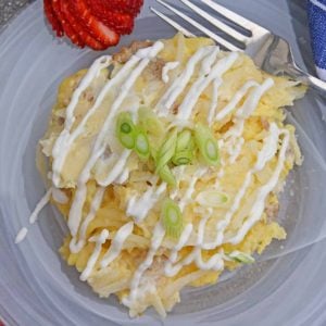 spoonful of breakfast casserole with sour cream drizzle