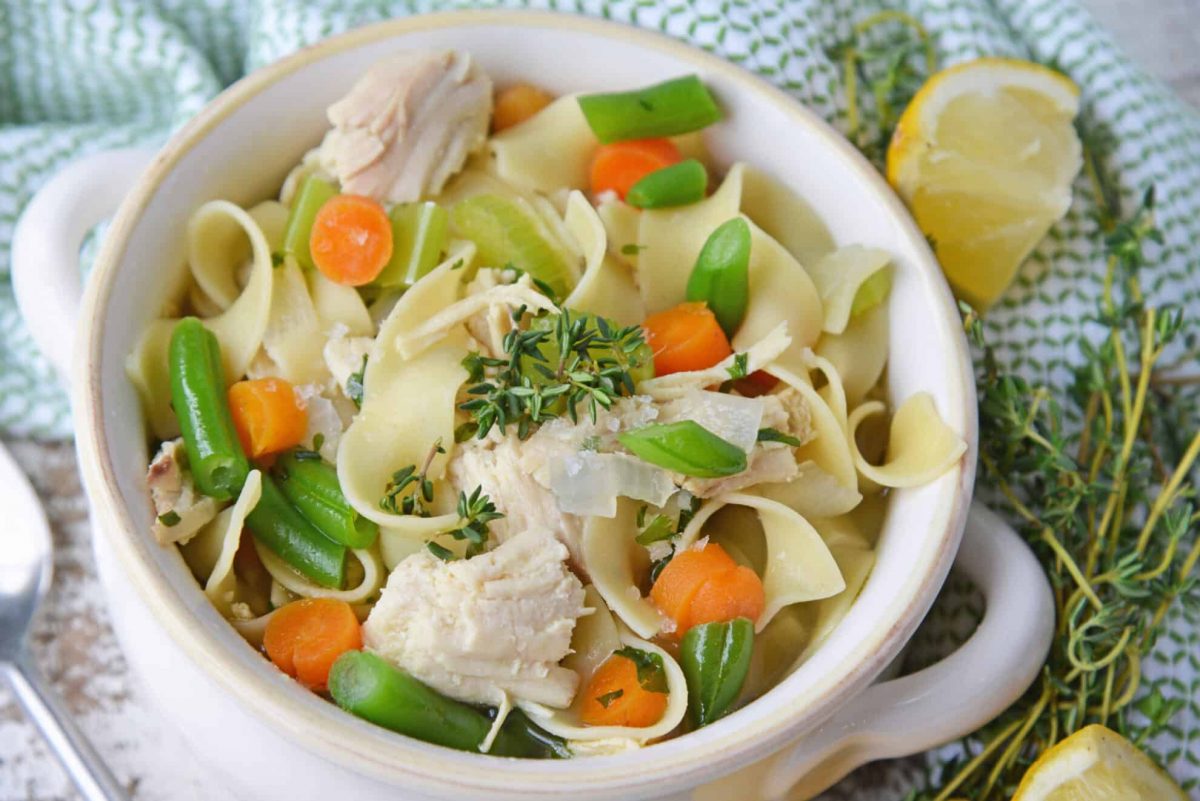 Angle of chicken noodle soup in a soup crock 