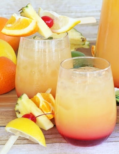 glasses of rum punch with fruit garnishes