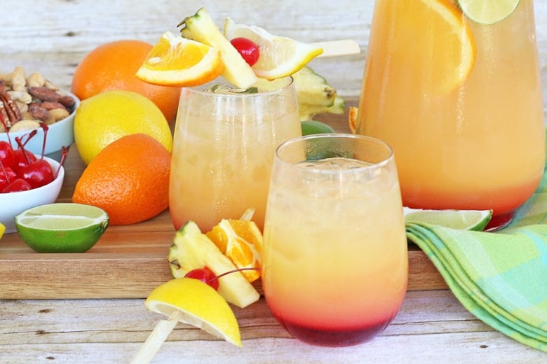 glasses of rum punch with fruit garnishes 