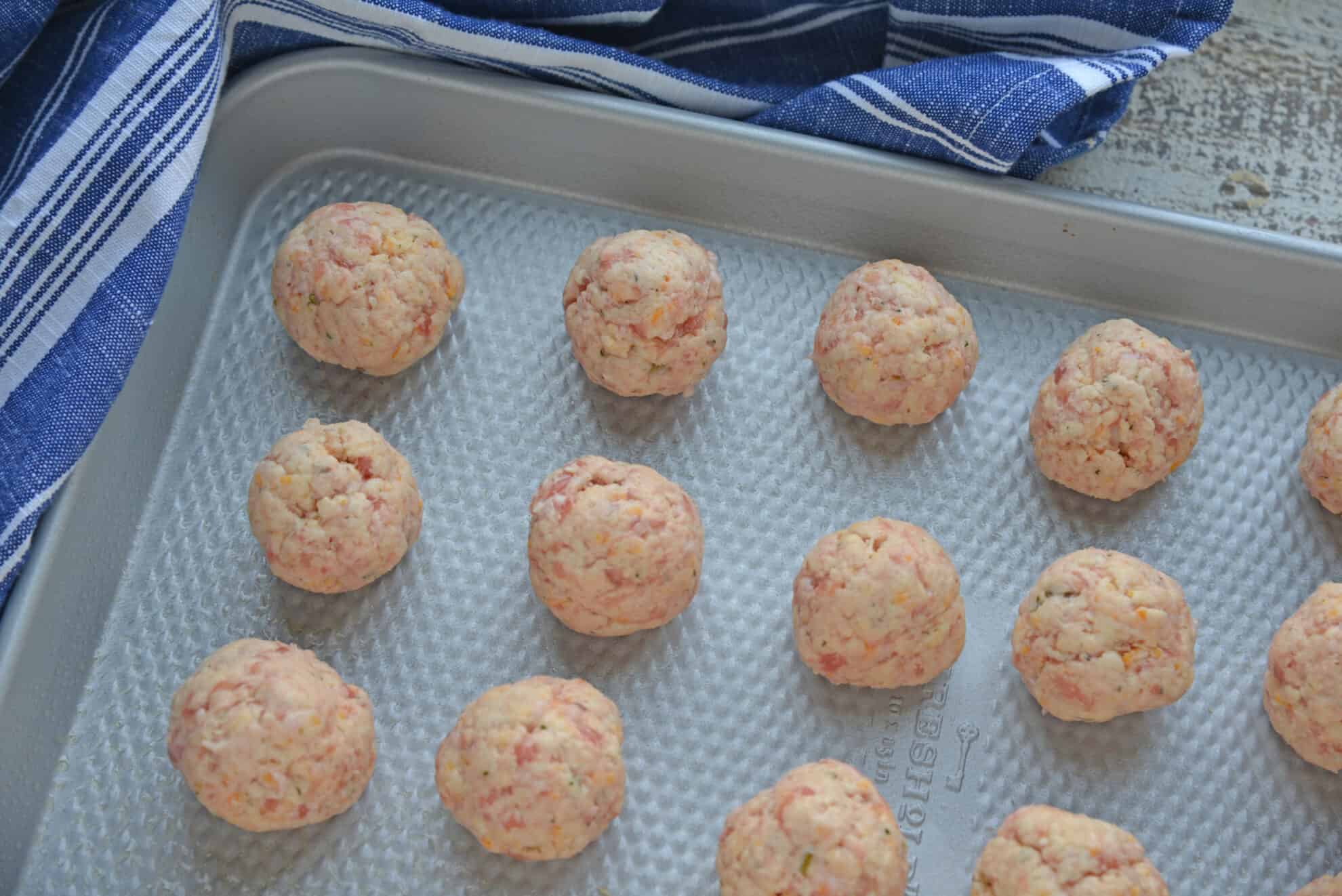 raw sausage balls on sheet pan