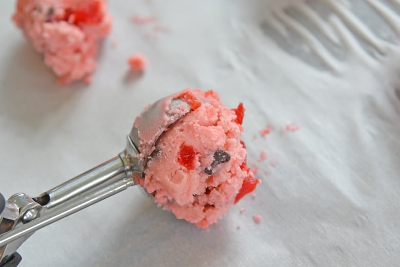 Cherry Chocolate Chip Cookie Dough in a cookie scoop onto parchment paper 