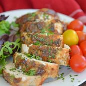 rolled turkey breast on a white plate