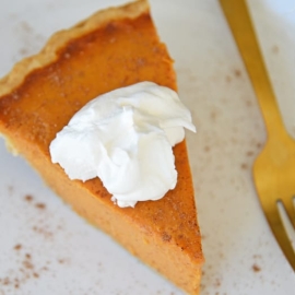 Slice of pumpkin pie with whipped cream