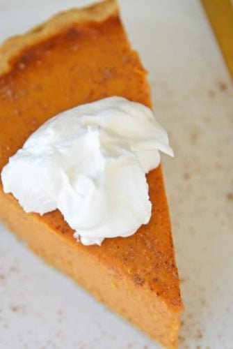 Slice of pumpkin pie with whipped cream