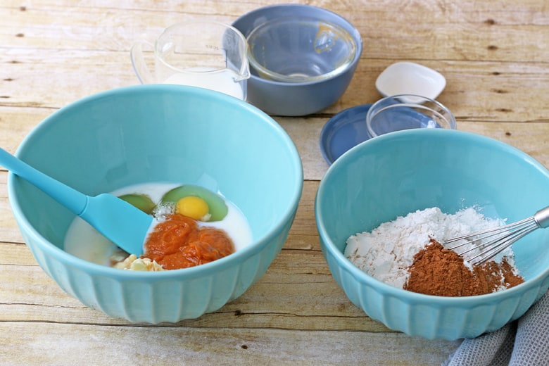 Ingredients for pumpkin waffles in blue mixing bowls 