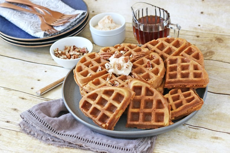 Pumpkin waffles spread out on a table 