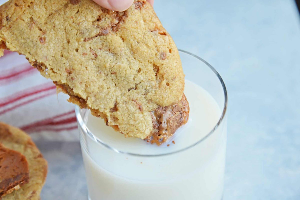 Rolo cookie dipping into a glass of milk 