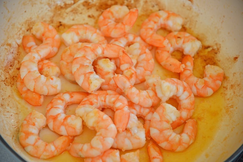 Sauteed pink shrimp in a enameled skillet  