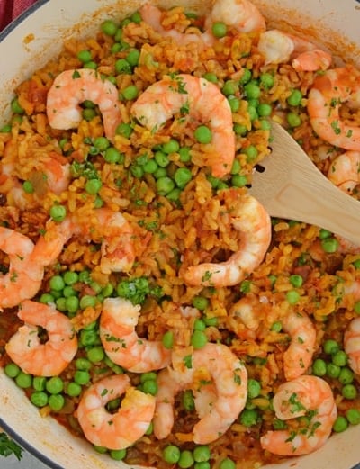 A bowl of food on a plate, with Paella