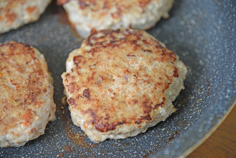 Cooked turkey burger patty in a skillet 