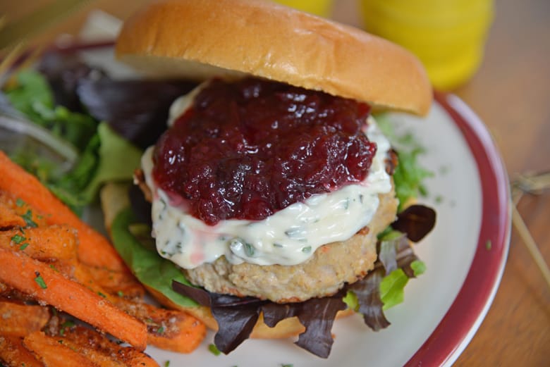 Turkey burger with leafy greens and brioche bun ajar 