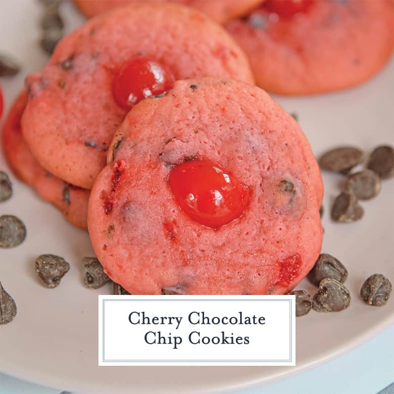 Close up of cherry chocolate chip cookies on a pink plate surrounding by loose chocolate chips 