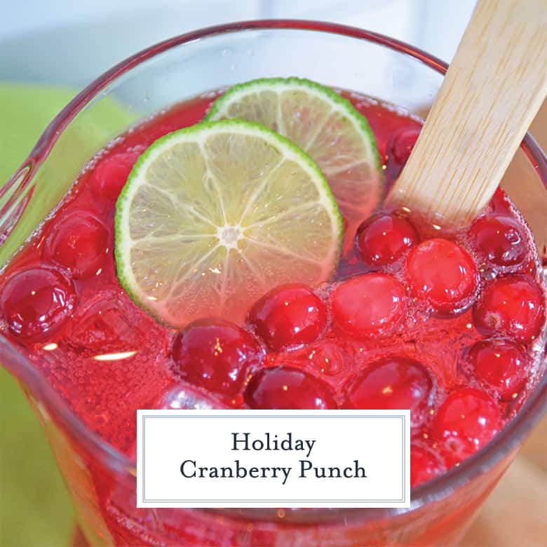 Overhead view of cranberry punch in a pitcher with lime wedges 