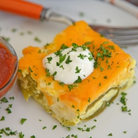 slice of chile relleno casserole with sour cream and salsa