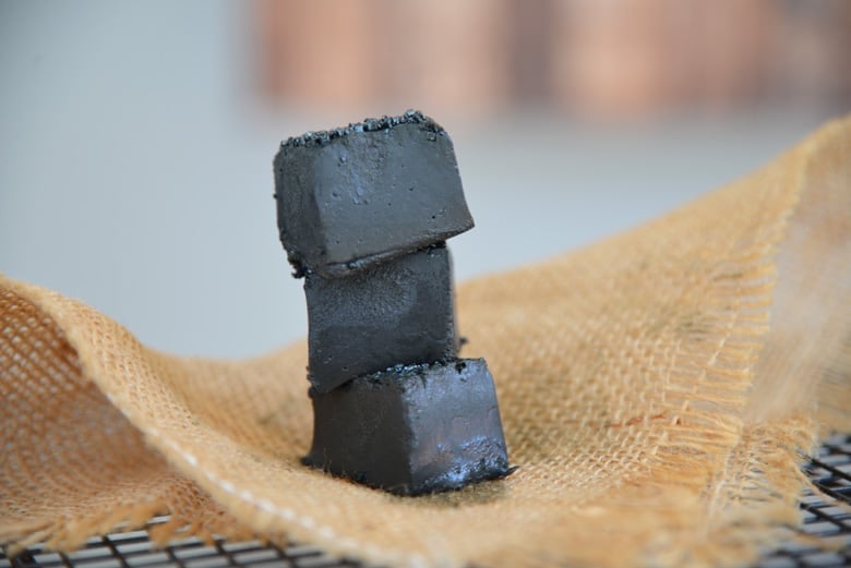 Stack of three pieces of black fudge 