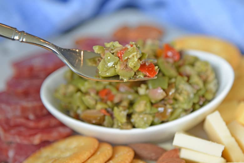 Olive tapenade on a small silver serving fork 