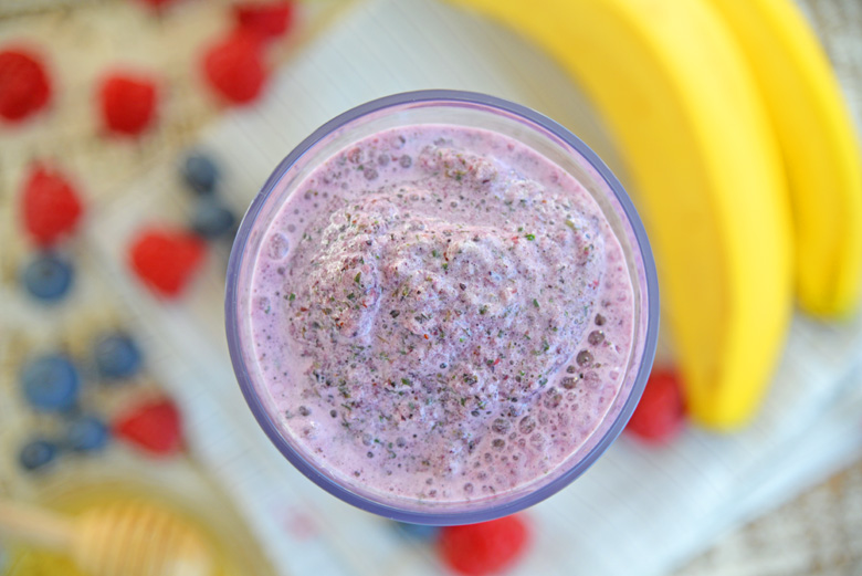 Overhead of purple berry smoothie in a glass 