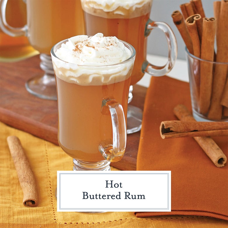 Hot Buttered Rum in a clear glass mug with whipped cream 