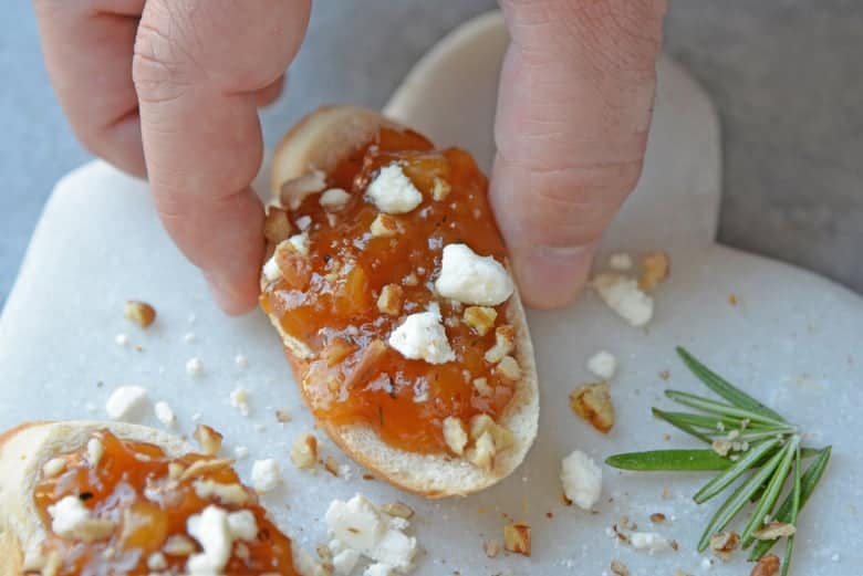 hand reaching in for pear and apricot crostini 