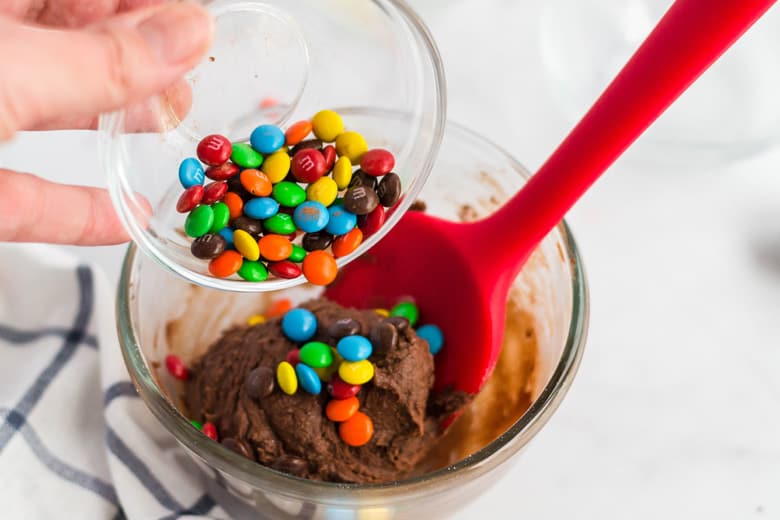 M&Ms pouring into edible cookie dough