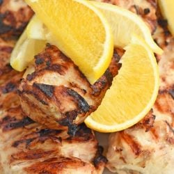 close up of lemon wedges with grilled chicken
