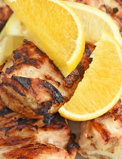 close up of lemon wedges with grilled chicken