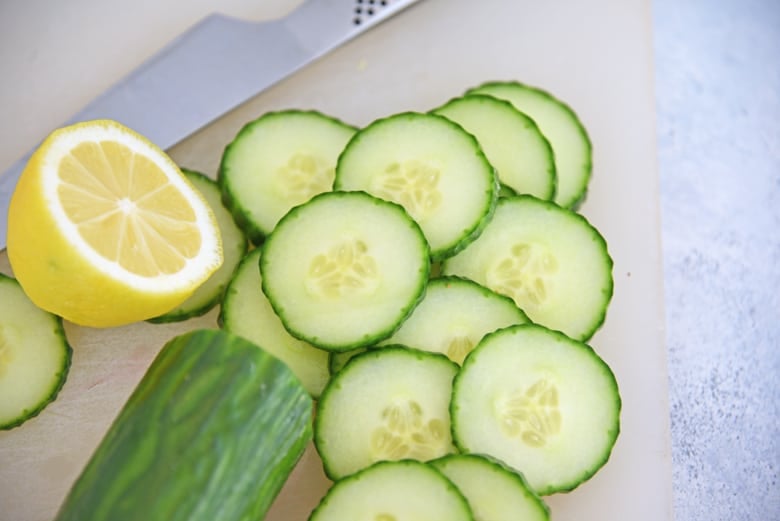 Sliced cucumbers and lemon wedge 
