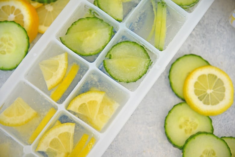 Close up of lemons and cucumbers in an ice cube tray 