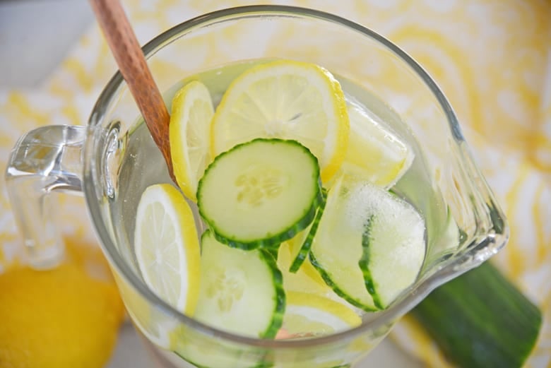 detox water in a pitcher with copper stirring stick 