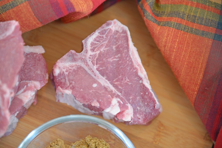 lamb loin chop on a wood cutting board 