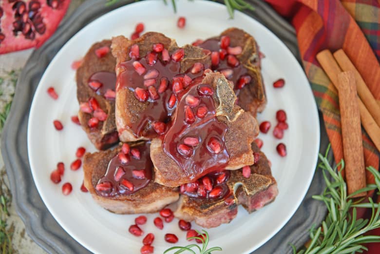 pomegranate lamb chops on a white platter