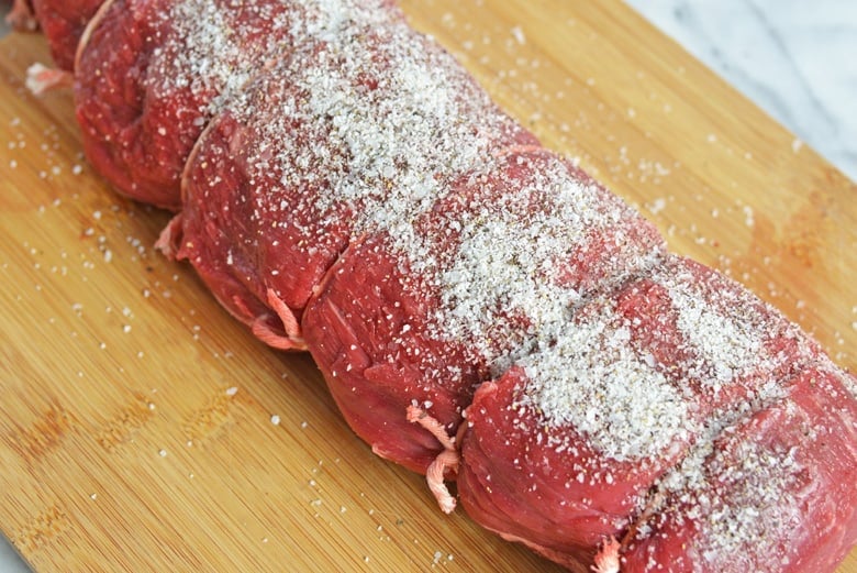 Salted beef tenderloin on a cutting board 