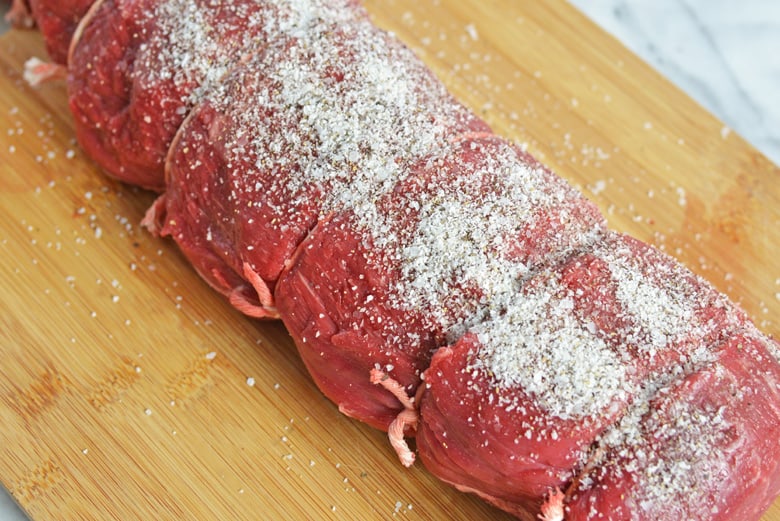 Salted beef tenderloin on a cutting board