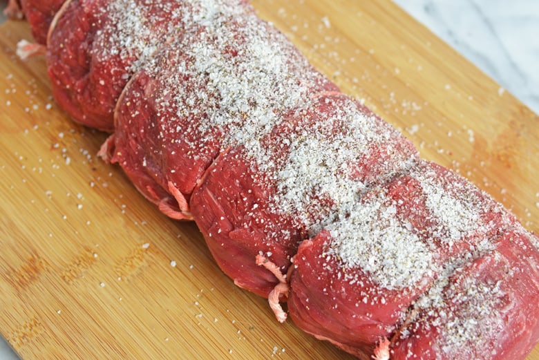 Salted beef tenderloin on a cutting board 