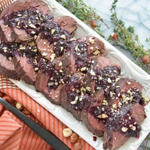 serving platter of beef tenderloin with blueberry sauce