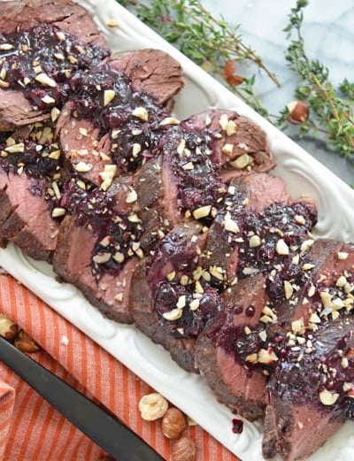 serving platter of beef tenderloin with blueberry sauce