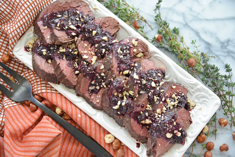 serving platter of beef tenderloin with blueberry sauce