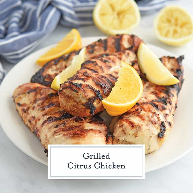 Grilled Chicken with Lemons on a White Plate 