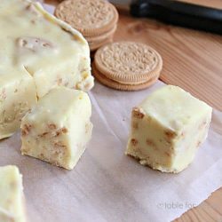 Lemon oreo fudge on parchment paper with lemon oreos