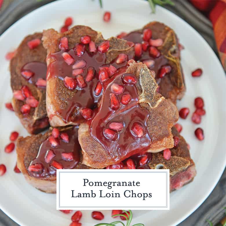 Lamb loin chops on a white plate with pomegranate sauce.