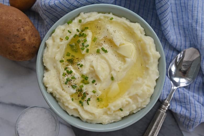 Homemade Mashed Potatoes in a Blue Serving Bowl